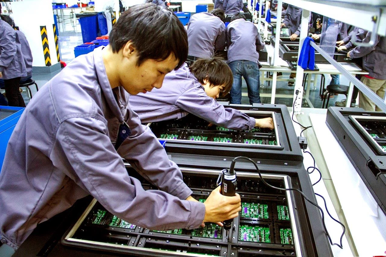 An Abcoya technician assembling the electronics inside an LED display cabinet