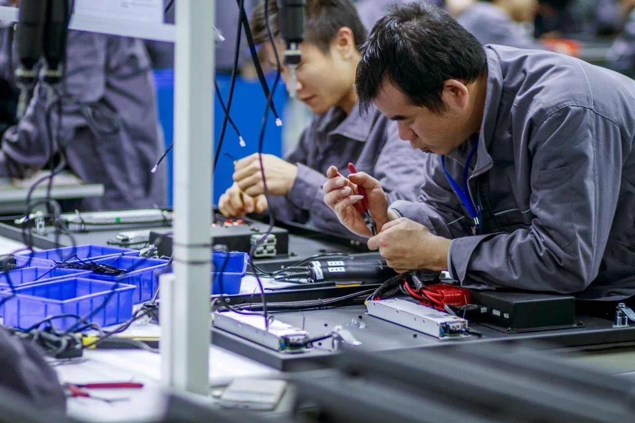 Abcoya technicians working together on display electronics
