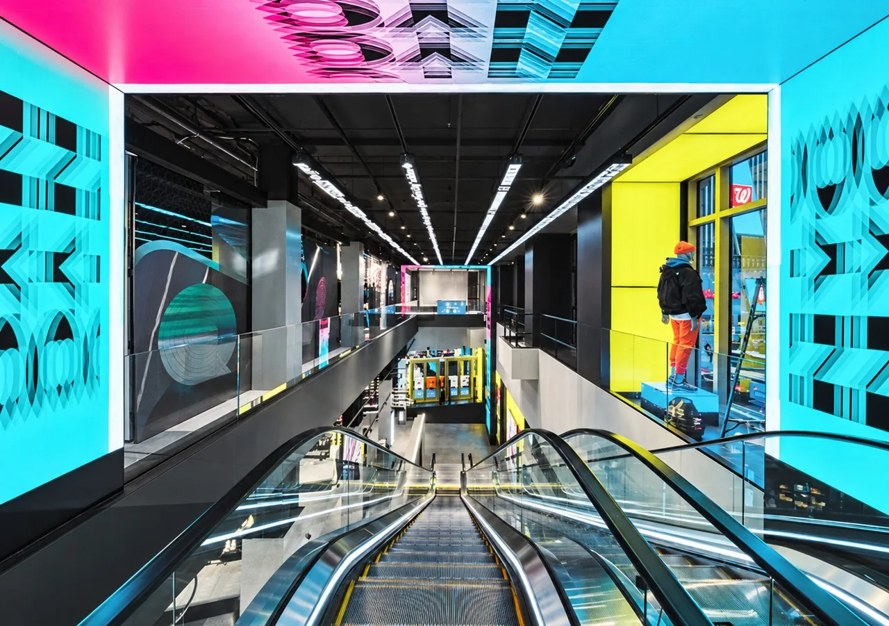 A retail escalator surrounded by integrated digital displays