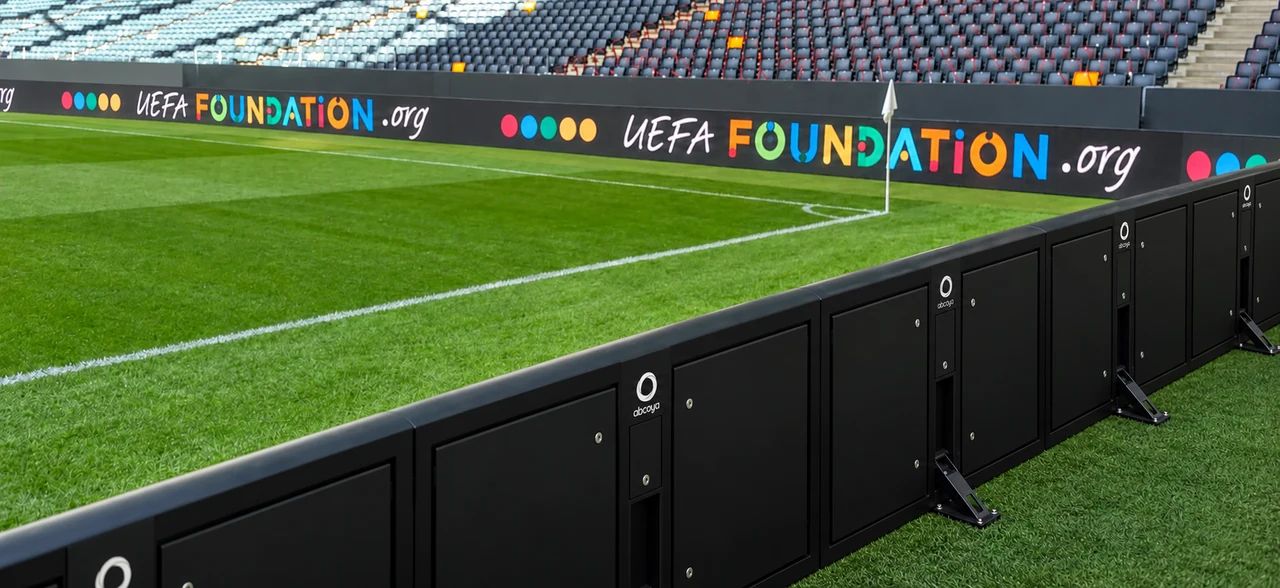 Reference photograph of a stadium with pitchside and overhead LED displays